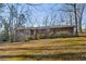 A charming brick house with a well-maintained lawn surrounded by mature trees at 1237 Samuel St, Marietta, GA 30008