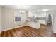 Eat-in kitchen showcasing granite countertops, white cabinetry, and a modern chandelier at 1237 Samuel St, Marietta, GA 30008
