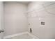 A small laundry room with tiled floors and a single wire rack for storage at 3935 Cordano Ln, Lawrenceville, GA 30044