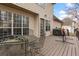 Back deck with outdoor dining set and grill, overlooks beautiful trees and backyard at 7810 Rose Ct, Cumming, GA 30040