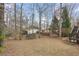 Large back yard with trees including trampoline, outbuilding, and deck at 7810 Rose Ct, Cumming, GA 30040