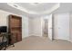 Finished basement with carpeting showing door to bath, an armoire, and a nearby room at 7810 Rose Ct, Cumming, GA 30040