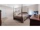 Large bedroom featuring carpeted floors, a four-poster bed, and dark wood furniture for a warm and inviting space at 7810 Rose Ct, Cumming, GA 30040