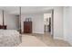 Bedroom featuring neutral walls and carpet with a partial view of a bathroom for convenience and functionality at 7810 Rose Ct, Cumming, GA 30040