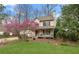 View of house with lovely front yard, sidewalk, blossoming tree, and welcoming front porch at 7810 Rose Ct, Cumming, GA 30040