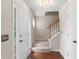 Inviting foyer features hardwood floors, staircase, coat closet, and stylish front door at 7810 Rose Ct, Cumming, GA 30040