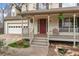 Inviting front porch with seating, potted plants, and a charming entryway with stylish door at 7810 Rose Ct, Cumming, GA 30040