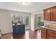 Bright kitchen with a blue island, wood cabinets, and an exterior door with a view to the outside at 7810 Rose Ct, Cumming, GA 30040