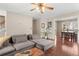 Open-concept living room with hardwood floors, fireplace, neutral walls, and an open view to the dining area at 7810 Rose Ct, Cumming, GA 30040