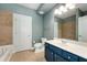 Bathroom with blue walls, blue vanity, and a tub and shower at 2230 Cheshire Bridge Ne Rd # 410, Atlanta, GA 30324