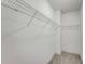 An empty walk-in closet with installed metal storage racks and carpeted floors at 2230 Cheshire Bridge Ne Rd # 410, Atlanta, GA 30324