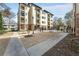 Multi-story condo building with balconies, landscaped grounds, a sidewalk, and a community pool area at 2230 Cheshire Bridge Ne Rd # 410, Atlanta, GA 30324