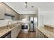 Kitchen with granite counters, stainless appliances and grey cabinets at 2230 Cheshire Bridge Ne Rd # 410, Atlanta, GA 30324