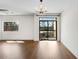 Spacious living room with wood floors, chandelier, large windows, and a balcony overlooking trees at 2230 Cheshire Bridge Ne Rd # 410, Atlanta, GA 30324
