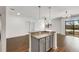 Inviting living space featuring wood floors, an island counter, and large windows for natural light at 2230 Cheshire Bridge Ne Rd # 410, Atlanta, GA 30324