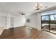 Bright, airy living room with dark wood floors, balcony, and an elegant chandelier at 2230 Cheshire Bridge Ne Rd # 410, Atlanta, GA 30324