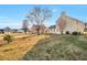 Exterior shot of backyard with lawn and other nearby homes at 4410 Millenium View Ct, Snellville, GA 30039