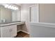A well-lit bathroom featuring a granite countertop with ample cabinet space at 4410 Millenium View Ct, Snellville, GA 30039