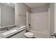 A tiled shower and tub in the bathroom with a granite vanity and chrome fixtures at 4410 Millenium View Ct, Snellville, GA 30039