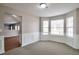 Open-concept dining area with carpet flooring and windows at 4410 Millenium View Ct, Snellville, GA 30039