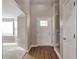 Bright entryway featuring a hardwood floor, white front door, and staircase access at 4410 Millenium View Ct, Snellville, GA 30039