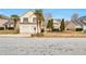 Inviting two-story home featuring a well-maintained lawn, palm trees, and a two-car garage at 4410 Millenium View Ct, Snellville, GA 30039