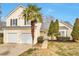 Charming two-story home with attached two-car garage and beautifully landscaped front yard at 4410 Millenium View Ct, Snellville, GA 30039
