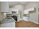 Bright kitchen features granite counters, white cabinets, and hardwood style floors at 4410 Millenium View Ct, Snellville, GA 30039