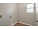 Utility room featuring hardwood floors and a window at 4410 Millenium View Ct, Snellville, GA 30039