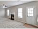 Comfortable living area features fireplace, neutral carpet, ceiling fan, and natural light at 4410 Millenium View Ct, Snellville, GA 30039