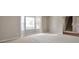 Neutral living room with large windows allowing for an abundance of natural light at 4410 Millenium View Ct, Snellville, GA 30039