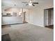 Open-concept living room with vaulted ceiling, neutral carpet, and seamless transition to kitchen at 4410 Millenium View Ct, Snellville, GA 30039