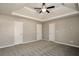 Spacious main bedroom with tray ceiling, neutral walls, and three doors at 4410 Millenium View Ct, Snellville, GA 30039