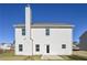 Back exterior of home featuring a chimney and level backyard at 471 Charleston Pl, Villa Rica, GA 30180