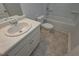 Well-lit bathroom featuring a shower-tub combination, vanity sink, modern toilet, and tile flooring at 471 Charleston Pl, Villa Rica, GA 30180