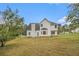 Expansive backyard of a white two-story home with a chimney, offering ample space for outdoor activities and relaxation at 5080 Galleon Xing, Decatur, GA 30035