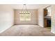 Traditional dining room featuring carpet, wainscotting, and a decorative light fixture for stylish meals at 5080 Galleon Xing, Decatur, GA 30035