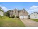 Beautiful two-story brick and vinyl home with a two-car garage, manicured lawn, and welcoming curb appeal at 5080 Galleon Xing, Decatur, GA 30035