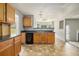 Functional kitchen featuring wood cabinets, black appliances, and durable flooring, ready for your personal touch at 5080 Galleon Xing, Decatur, GA 30035