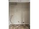 Unfinished laundry closet with flooring, plumbing, and electrical hookups ready for new appliances at 5080 Galleon Xing, Decatur, GA 30035