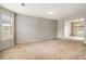 Spacious living room with neutral paint, carpet and natural light with a view to the dining room at 5080 Galleon Xing, Decatur, GA 30035