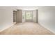Spacious living room with neutral carpet, large windows, and fresh paint ready for your personal touch at 5080 Galleon Xing, Decatur, GA 30035