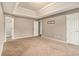 Large main bedroom with tray ceiling, neutral carpet, and multiple doors for added space and convenience at 5080 Galleon Xing, Decatur, GA 30035