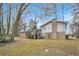 The backyard features a deck with brick and vinyl siding, and mature trees at 5140 Cowart Ct, Powder Springs, GA 30127