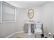 Compact bathroom featuring a pedestal sink, toilet, and a window at 5140 Cowart Ct, Powder Springs, GA 30127
