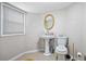 Simple powder room featuring a pedestal sink, toilet, and window for natural light at 5140 Cowart Ct, Powder Springs, GA 30127