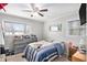 Cozy bedroom featuring a ceiling fan, natural light, and ample closet space at 5140 Cowart Ct, Powder Springs, GA 30127