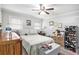 Bedroom with a comfortable bed, ceiling fan, and natural light from the windows at 5140 Cowart Ct, Powder Springs, GA 30127