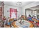 The dining area features a round table and chairs, with hardwood floors and natural light at 5140 Cowart Ct, Powder Springs, GA 30127