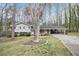 Inviting one-story home with a manicured lawn, a covered parking area and mature trees at 5140 Cowart Ct, Powder Springs, GA 30127